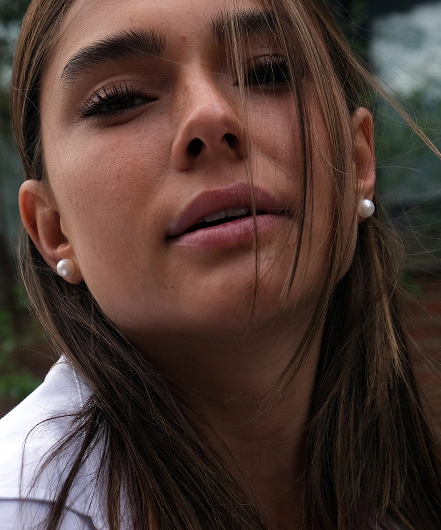 14kt Gold Maxi Studs - 8-9mm white round freshwater pearl earrings in 14kt yellow gold by Nishi Pearls, worn on a model