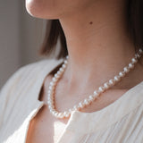 14kt Gold Midi Necklace - 7-8mm white freshwater pearl necklace in 14kt yellow gold, 18in, by Nishi Pearls, styled on a model