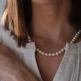 14kt Gold Midi Necklace - 7-8mm white freshwater pearl necklace in 14kt yellow gold, 18in, by Nishi Pearls, worn on a model