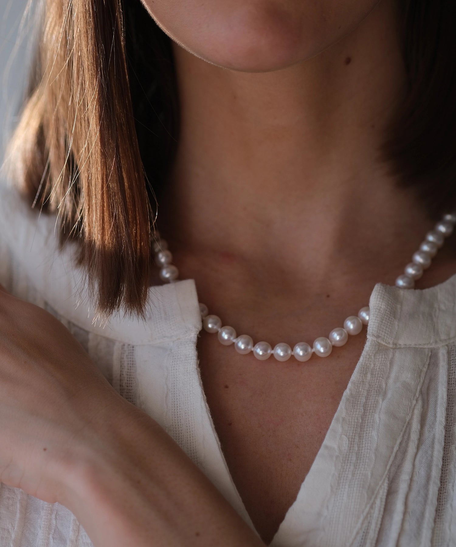 14kt Gold Midi Necklace - 7-8mm white freshwater pearl necklace in 14kt yellow gold, 18in, by Nishi Pearls, worn on a model