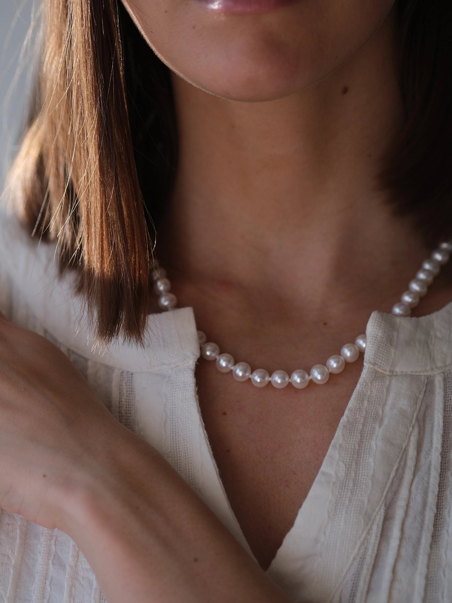14kt Gold Midi Necklace - 7-8mm white freshwater pearl necklace in 14kt yellow gold, 18in, by Nishi Pearls, worn on a model