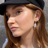 Azalea Hoops - mixed-size white baroque freshwater pearl earrings in yellow gold vermeil by Nishi Pearls, worn on a model
