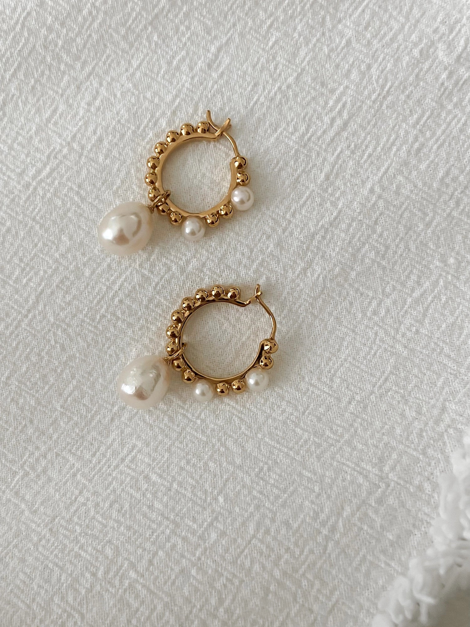 Beatrice Hoops - mixed-size white baroque freshwater pearl in yellow gold vermeil by Nishi Pearls, styled lifestyle photo