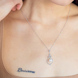 Bell Necklace - 8-9mm white freshwater pearls in sterling silver with topaz, 16.5-18in by Nishi Pearls, styled on a model