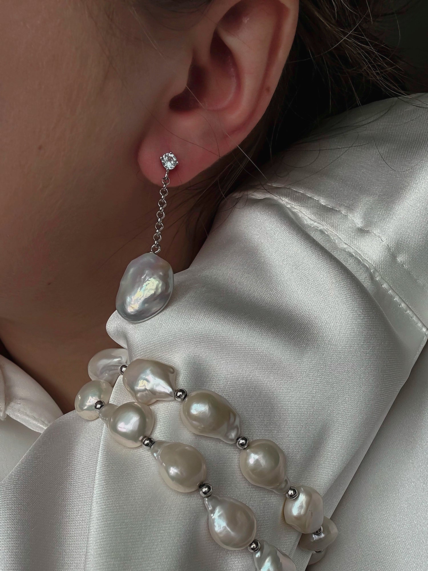 Bliss Earring - mixed-size white baroque freshwater pearl earrings in sterling silver by Nishi Pearls, worn on a model