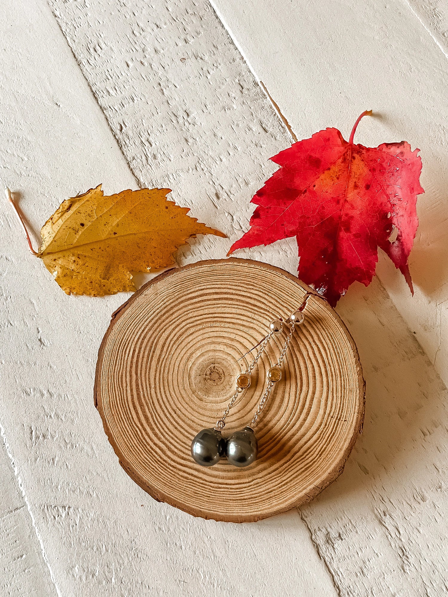 Citrine Earring - mixed-size black Tahitian pearl earrings in sterling silver by Nishi Pearls, styled lifestyle photo