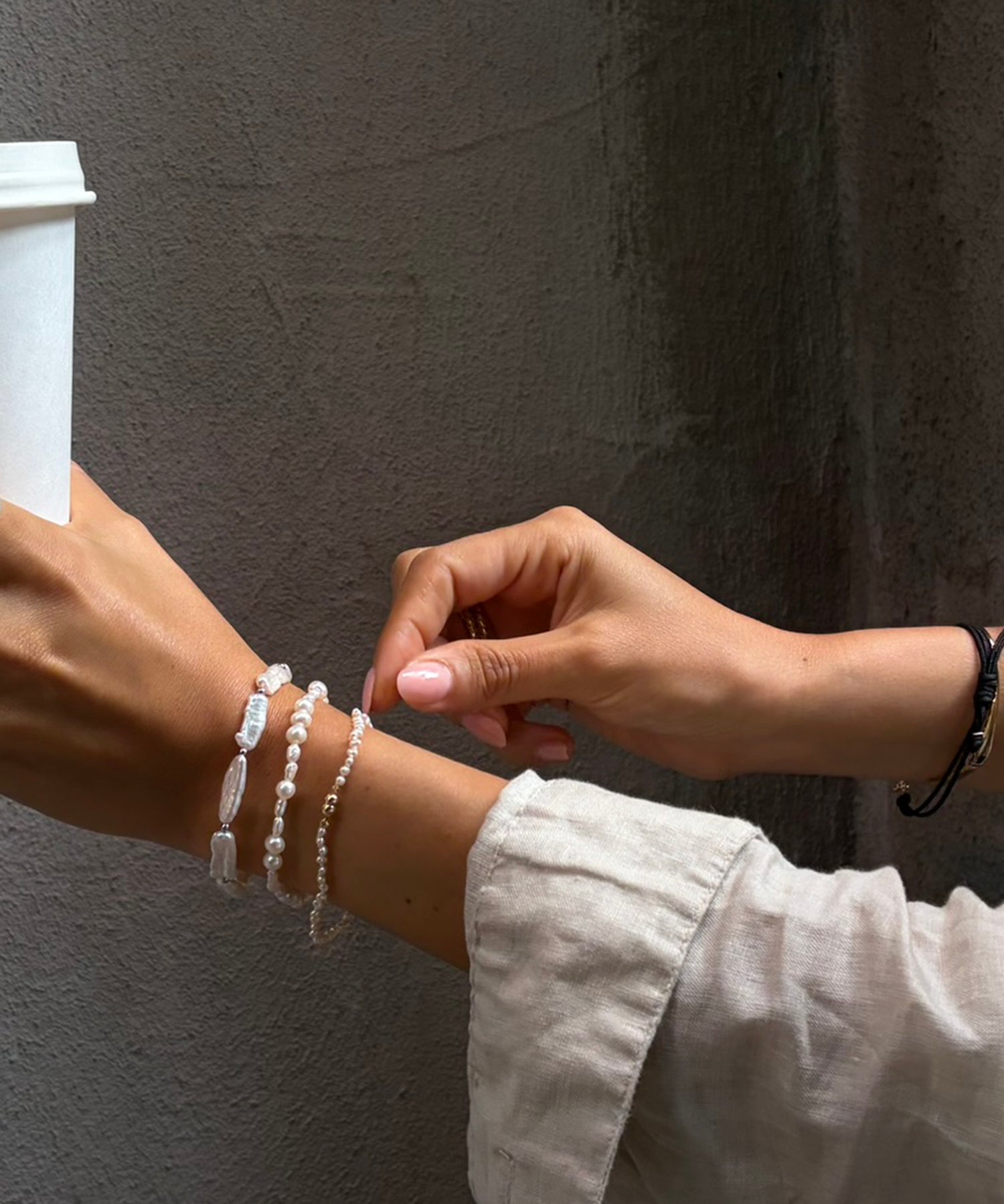 Cliquette Bracelet - 2-3mm white freshwater pearl magnetic bracelet in 14kt yellow gold by Nishi Pearls, worn on a model