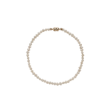 Cliquette Bracelet - 2-3mm white freshwater pearl magnetic bracelet in 14kt yellow gold by Nishi Pearls, studio view