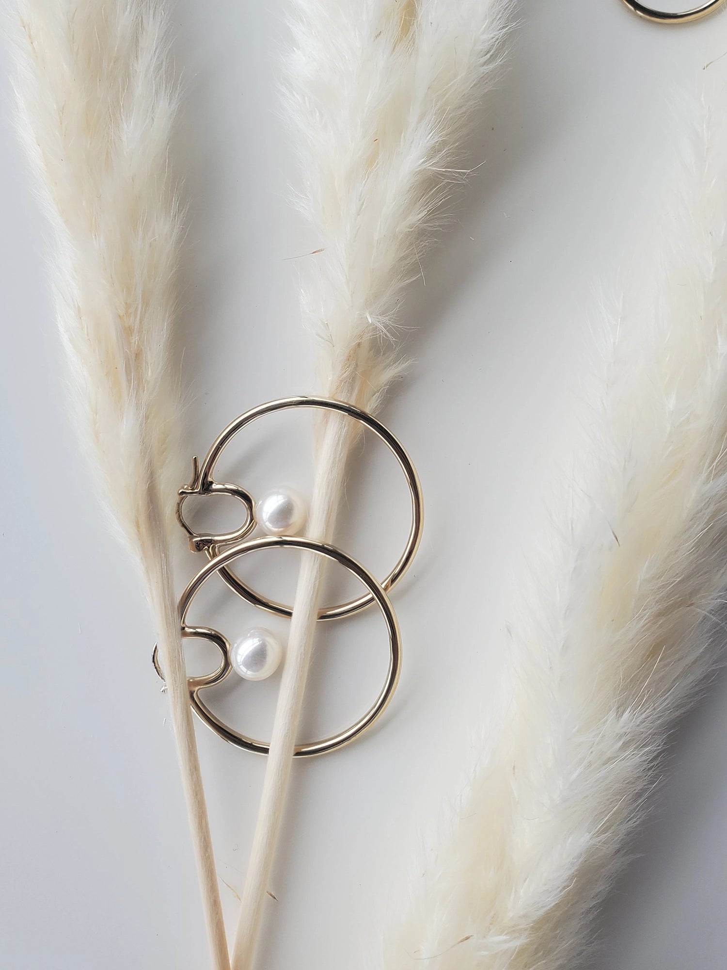 Cosmos Earring - 7-8mm white round freshwater pearl earrings in yellow gold vermeil by Nishi Pearls, styled lifestyle photo