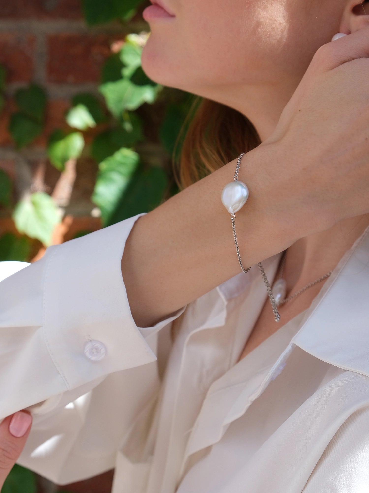 Daisy Bracelet - 14-15mm white baroque freshwater pearls in sterling silver, adjustable by Nishi Pearls, styled on a model