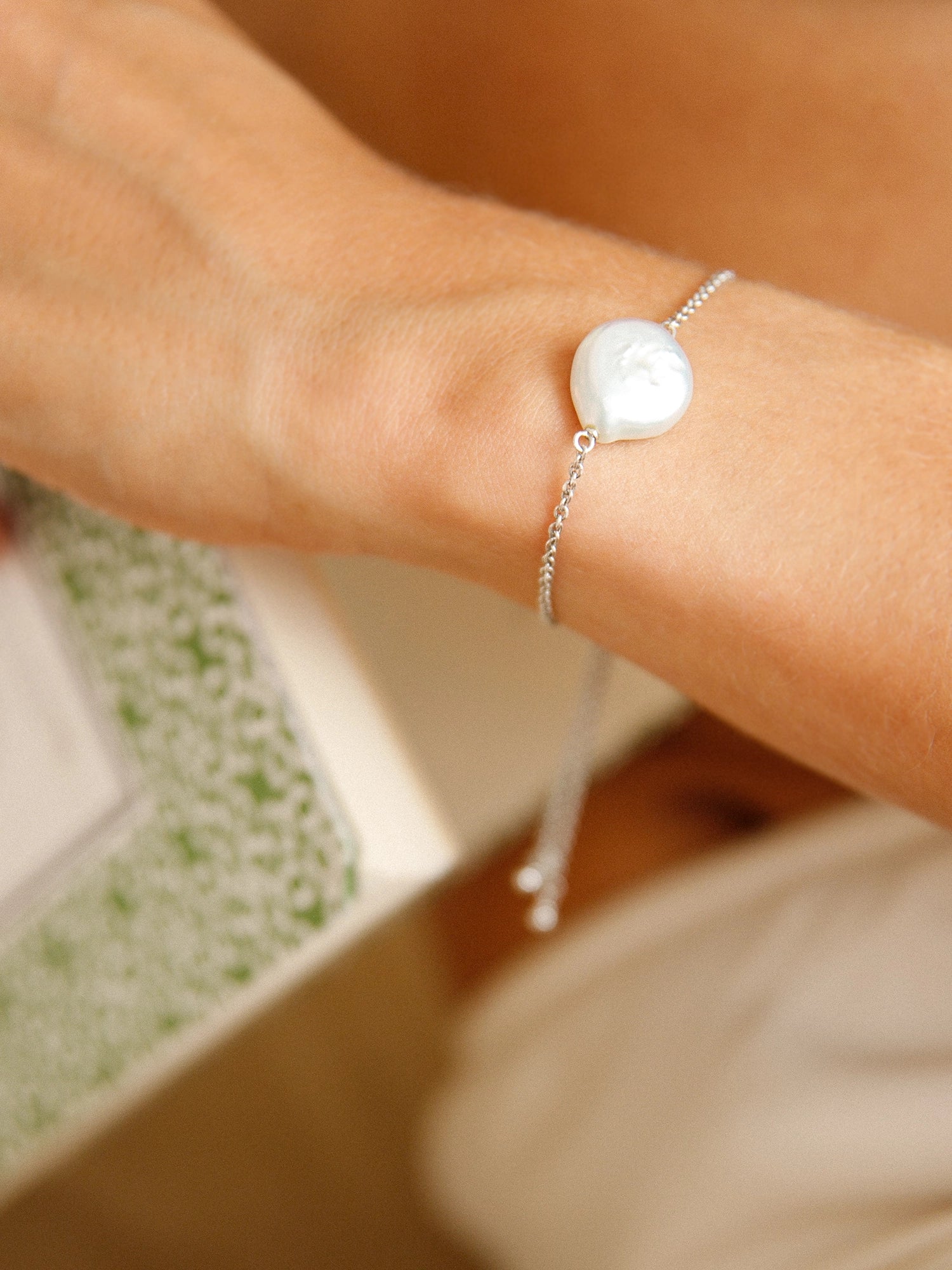Daisy Bracelet - 14-15mm white baroque freshwater pearls in sterling silver, adjustable by Nishi Pearls, worn on a model