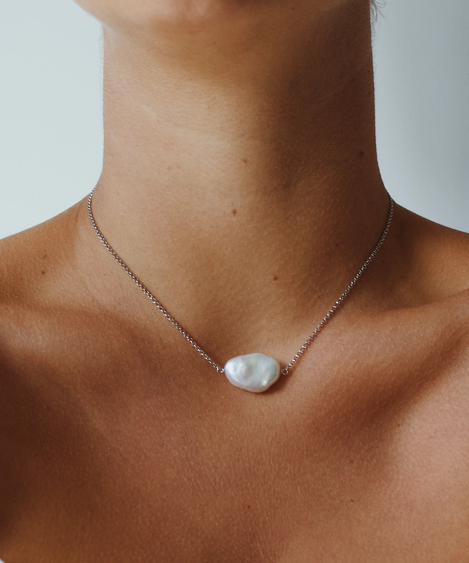Daisy Necklace - 14-15mm white baroque freshwater pearls in sterling silver, 15-17in by Nishi Pearls, worn on a model