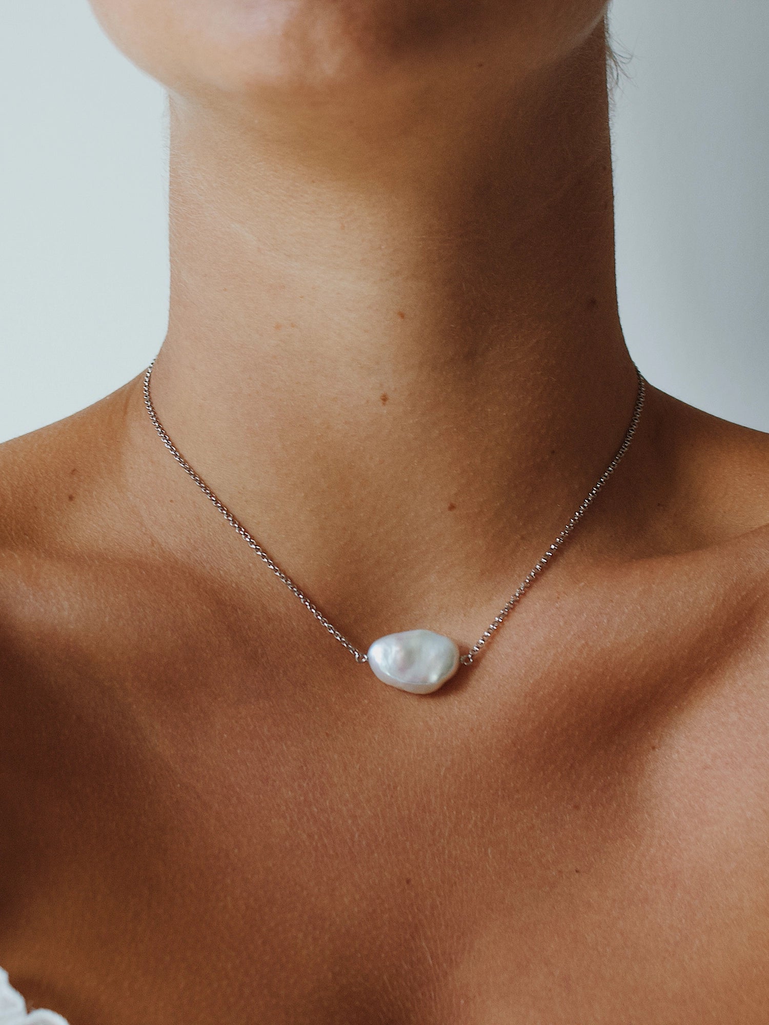 Daisy Necklace - 14-15mm white baroque freshwater pearls in sterling silver, 15-17in by Nishi Pearls, worn on a model