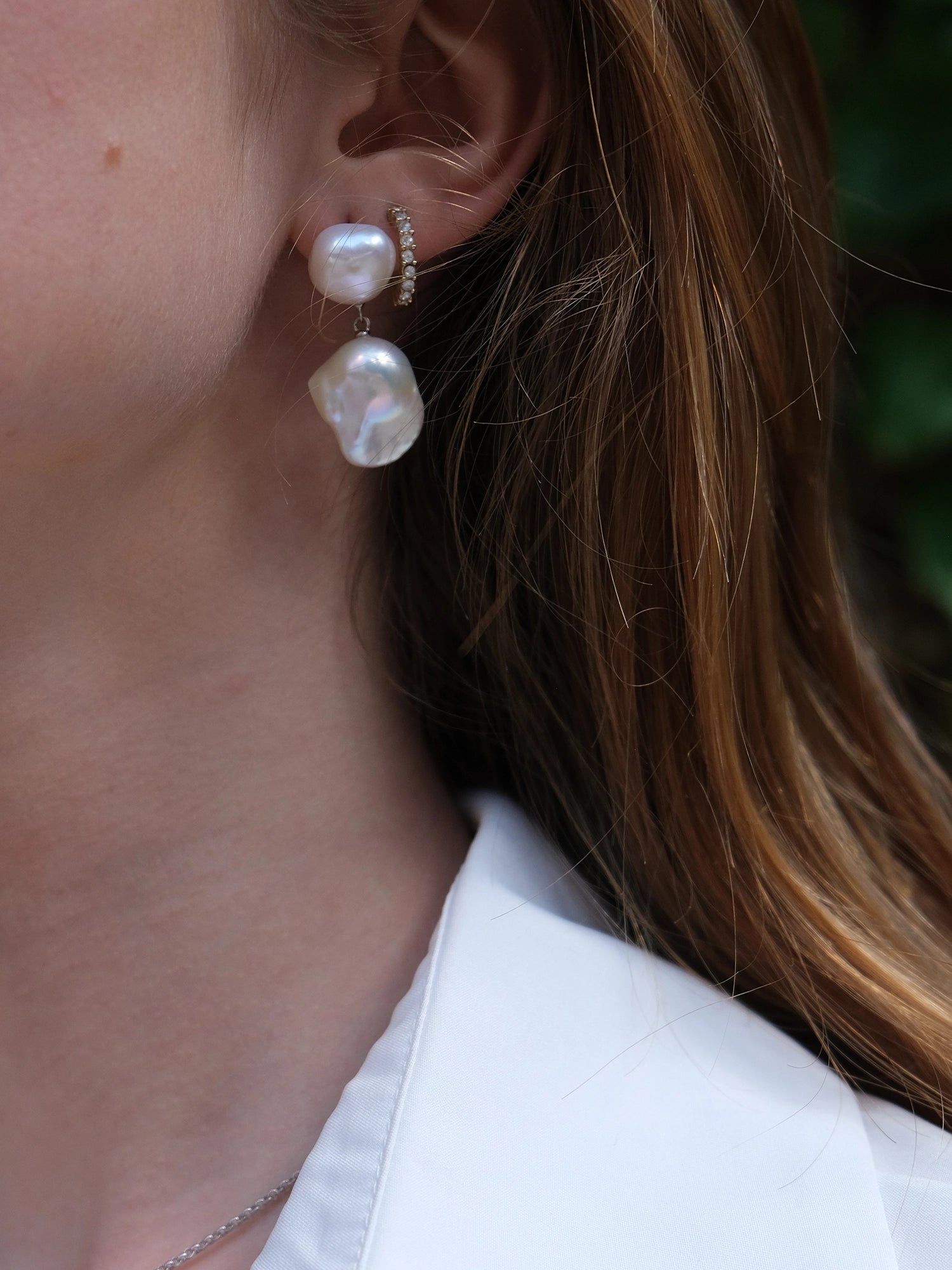 Daliah Earring - mixed-size white baroque freshwater pearl earrings in sterling silver by Nishi Pearls, styled on a model