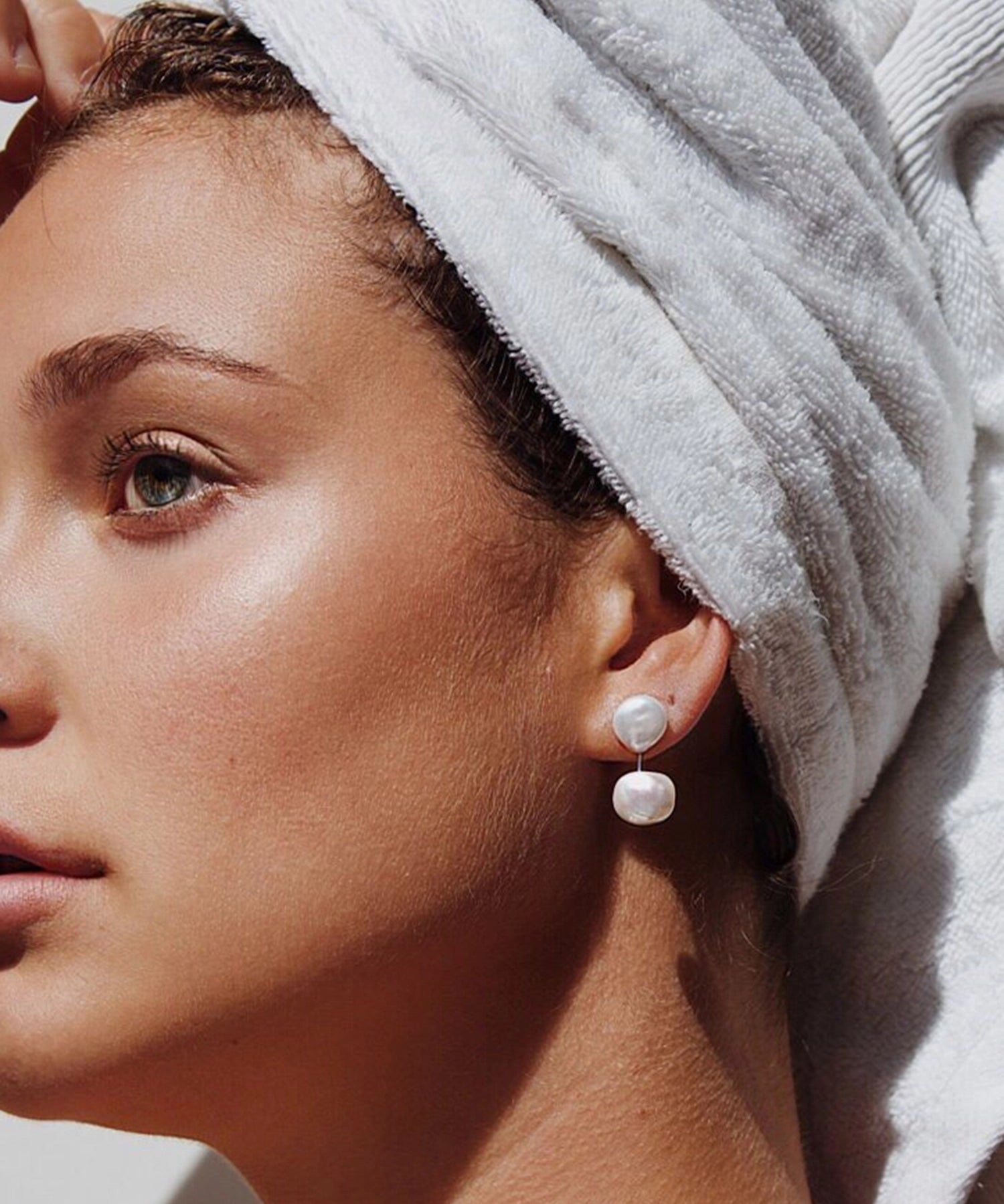 Daphne Jacket Earring - mixed-size white baroque freshwater pearl earrings in sterling silver by Nishi Pearls, on a model