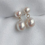 Drop Studs - mixed-size white freshwater pearl earrings in 14kt yellow gold by Nishi Pearls, styled lifestyle photo