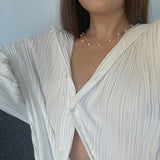 Gold Path Necklace - 6-7mm white freshwater pearls in 14kt yellow gold, 17.5-18in by Nishi Pearls, worn on a model