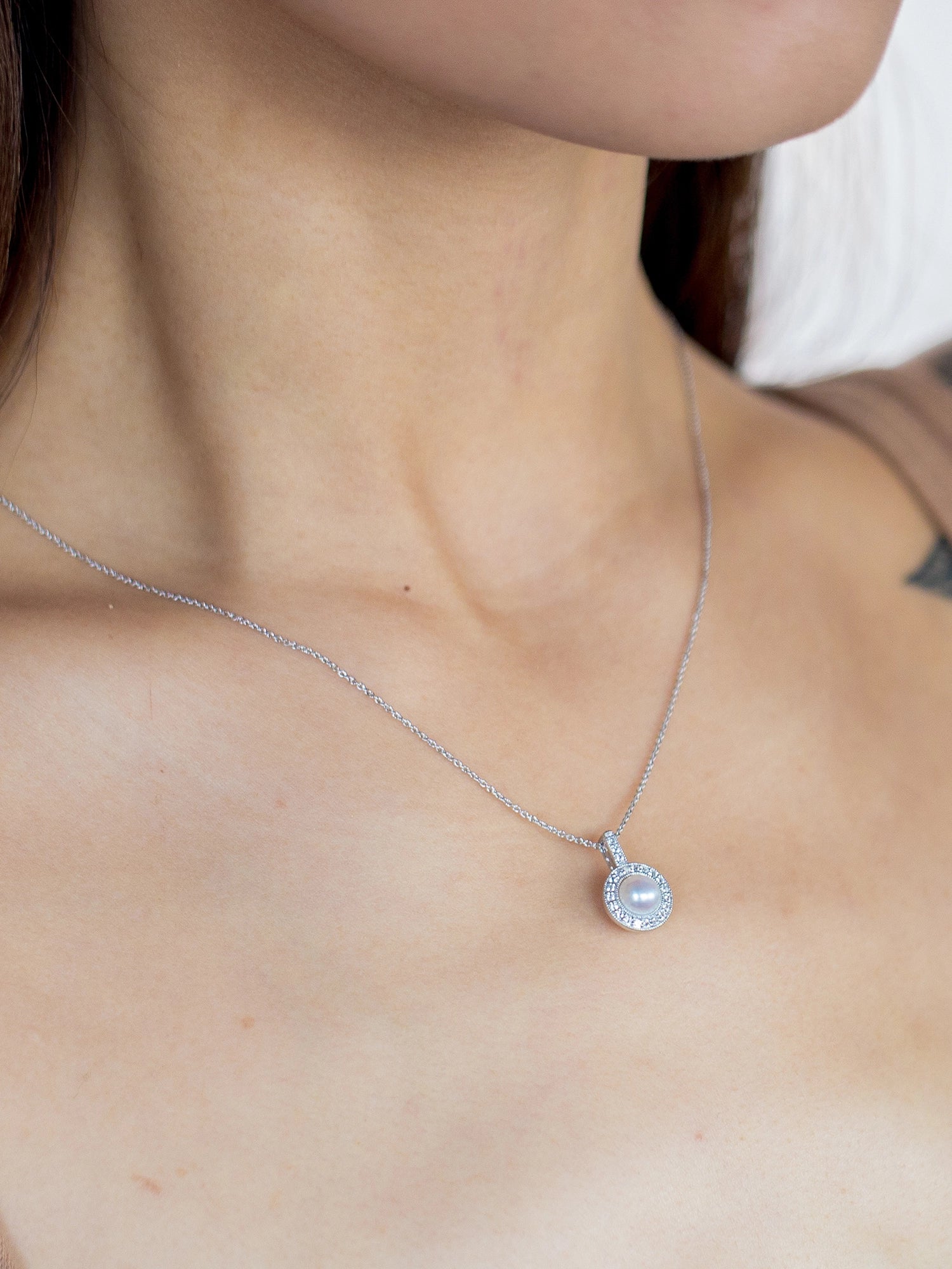 Halo Necklace - 6-7mm white freshwater pearl necklace in sterling silver with topaz, 18in by Nishi Pearls, worn on a model