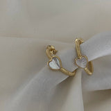 Hera Earring - white mother-of-pearl earrings in yellow gold vermeil by Nishi Pearls, styled lifestyle photo
