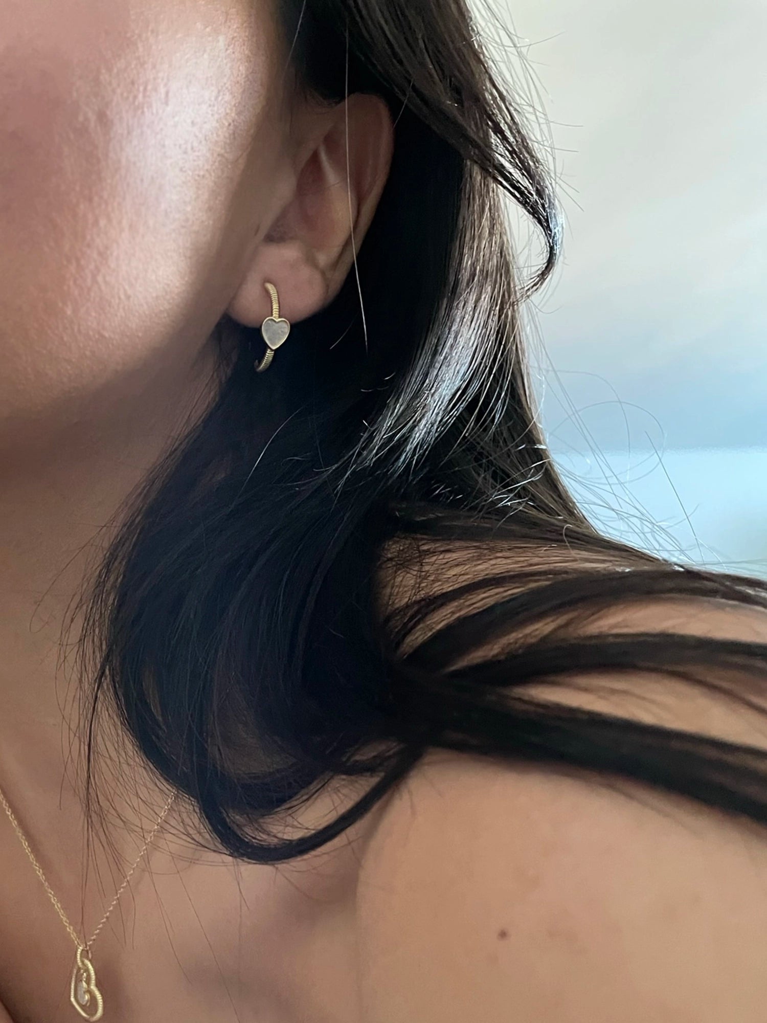 Hera Earring - white mother-of-pearl earrings in yellow gold vermeil by Nishi Pearls, worn on a model