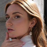 Holly Hoops - mixed-size white baroque freshwater pearl earrings in yellow gold vermeil, on a model by Nishi Pearls, angle