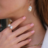 Holly Hoops - mixed-size white baroque freshwater pearl earrings in yellow gold vermeil by Nishi Pearls, styled on a model