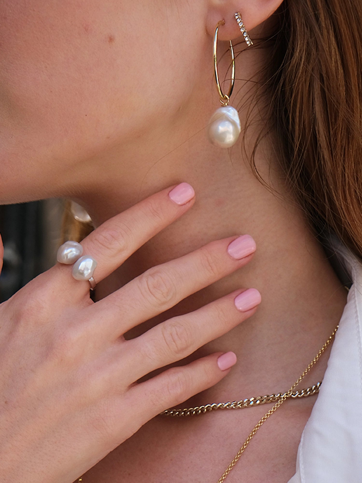 Holly Hoops - mixed-size white baroque freshwater pearl earrings in yellow gold vermeil by Nishi Pearls, styled on a model