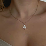Kite Necklace - white mother-of-pearl necklace in rose gold vermeil, 16.5-18in by Nishi Pearls, worn on a model